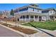 Two-story home with a charming front porch, manicured lawn, and street-side landscaping, enhancing its curb appeal at 2801 Cherry St, Denver, CO 80207