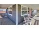 Inviting front porch with seating, charming decor, and windows, offering a cozy and welcoming entrance to the home at 2801 Cherry St, Denver, CO 80207