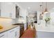 Modern kitchen featuring stainless steel appliances, and an extended quartz countertop at 2801 Cherry St, Denver, CO 80207