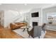 Inviting living room with staircase, fireplace, comfortable seating, and open layout at 2801 Cherry St, Denver, CO 80207