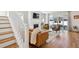Bright and open living room with stairs, fireplace, and sliding doors to the patio at 2801 Cherry St, Denver, CO 80207