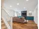 Open-concept living room with hardwood floors and a modern fireplace at 2801 Cherry St, Denver, CO 80207