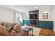 Comfortable living room with a TV over fireplace, and built in shelves at 2801 Cherry St, Denver, CO 80207