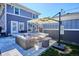 Relaxing outdoor patio featuring stylish wicker furniture, an umbrella, and a stone tile surface for outdoor enjoyment at 2801 Cherry St, Denver, CO 80207