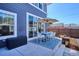 Outdoor patio with a table, chairs, blue rug, and a striped umbrella, perfect for outdoor dining and entertaining at 2801 Cherry St, Denver, CO 80207