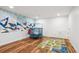 Fun play area with colorful wall art, a trampoline, and a play rug at 2801 Cherry St, Denver, CO 80207