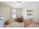 Cozy Bedroom with a crib, rocking chair, and playful decor at 2801 Cherry St, Denver, CO 80207