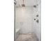 Luxury shower with gray stone tile, dual showerheads, glass doors, and a built-in bench at 2801 Cherry St, Denver, CO 80207