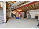 Unfinished basement with concrete floor provides ample storage and potential for customization at 23965 E Kettle Pl, Aurora, CO 80016