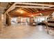 Spacious unfinished basement with exposed wood beams and concrete floor offers customization options at 23965 E Kettle Pl, Aurora, CO 80016