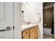 Small bathroom featuring a vanity, single sink, wooden cabinets and access to a shower/tub at 23965 E Kettle Pl, Aurora, CO 80016