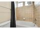 Simple bathroom with a standard bathtub, a tiled surround, and a shower curtain at 23965 E Kettle Pl, Aurora, CO 80016