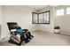 Bright bonus room featuring a massage chair, neutral carpet, and corner windows at 23965 E Kettle Pl, Aurora, CO 80016
