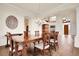 Spacious dining room with elegant decor and a view to the home's entryway and grand staircase at 23965 E Kettle Pl, Aurora, CO 80016