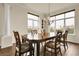 Bright dining room with large windows, a stylish chandelier, and elegant wooden table at 23965 E Kettle Pl, Aurora, CO 80016