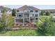 Multi-level home boasts multiple balconies, a stone facade, and a well-maintained lawn at 23965 E Kettle Pl, Aurora, CO 80016