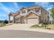 Beautiful two-story home featuring a stone facade and a spacious three car driveway at 23965 E Kettle Pl, Aurora, CO 80016