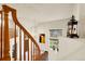 View of the light and airy foyer with staircase and pendant light, highlighting the home's bright interior at 23965 E Kettle Pl, Aurora, CO 80016