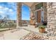 Inviting front porch with stone columns and decorative water fountain at 23965 E Kettle Pl, Aurora, CO 80016