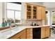 Bright kitchen features granite countertops, light wood cabinets, black appliances, and large window view at 23965 E Kettle Pl, Aurora, CO 80016
