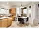 Bright eat-in kitchen features light wood cabinets, granite countertops, and a charming breakfast nook at 23965 E Kettle Pl, Aurora, CO 80016