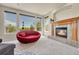 Cozy living room with a fireplace, large windows with views to the exterior deck at 23965 E Kettle Pl, Aurora, CO 80016