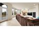Bright living room features a cozy fireplace, large windows, and access to the deck at 23965 E Kettle Pl, Aurora, CO 80016