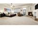 Spacious main bedroom featuring a cozy fireplace, sitting area, and ample natural light from the window at 23965 E Kettle Pl, Aurora, CO 80016