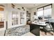 Home office featuring French doors, a large window, and a modern desk setup at 23965 E Kettle Pl, Aurora, CO 80016