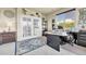 Home office with French doors, large windows and a dark wood desk at 23965 E Kettle Pl, Aurora, CO 80016