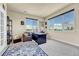 Bright home office with large windows, a desk, and comfortable seating with natural light at 23965 E Kettle Pl, Aurora, CO 80016