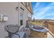Outdoor seating area with stone fire pit on a balcony with views of trees and blue sky at 23965 E Kettle Pl, Aurora, CO 80016