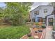 Serene backyard featuring a well-maintained lawn, patio area, and garden beds at 824 S Medea Way, Denver, CO 80209