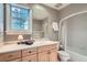 Cozy bathroom with natural light, a tiled shower, and built-in storage, offering a functional space at 824 S Medea Way, Denver, CO 80209