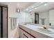 Bright bathroom featuring dual sinks, a large mirror, and modern fixtures, offering a clean and functional space at 824 S Medea Way, Denver, CO 80209