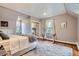 Comfortable bedroom with ample natural light, neutral decor, and stylish rug for a calming atmosphere at 824 S Medea Way, Denver, CO 80209