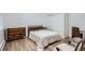 Simple bedroom features a bed, dresser, natural light, and minimalist decor, providing a calming space at 824 S Medea Way, Denver, CO 80209