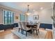 Formal dining room with a round wood table and a stylish rug at 824 S Medea Way, Denver, CO 80209