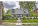 Charming two-story home with dormer windows, white picket fence, and well-manicured lawn at 824 S Medea Way, Denver, CO 80209