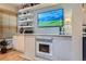 Cozy fireplace with built-in shelving and modern design, ideal for relaxing and enjoying the home at 824 S Medea Way, Denver, CO 80209
