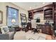 Well-lit home office includes custom built-ins, plush seating, and an organized workspace, perfect for productivity at 824 S Medea Way, Denver, CO 80209