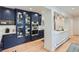 Modern kitchen featuring navy cabinets, quartz countertops and stainless steel appliances at 824 S Medea Way, Denver, CO 80209