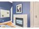 Modern living room boasts a fireplace, blue accent wall, and stylish decor, offering a sophisticated ambiance at 824 S Medea Way, Denver, CO 80209