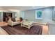 Bright living room with a modern sofa, area rug, and natural light, perfect for relaxation and entertaining at 824 S Medea Way, Denver, CO 80209