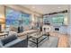 Inviting living room featuring a fireplace, hardwood floors, and large windows at 824 S Medea Way, Denver, CO 80209