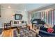 Elegant living room featuring a bay window, hardwood floors, and stylish decor at 824 S Medea Way, Denver, CO 80209