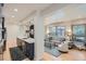 Open living space featuring a modern kitchen and a comfortable sitting area at 824 S Medea Way, Denver, CO 80209