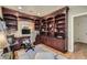 Well-lit office features custom built-in wooden bookshelves, drawers, cabinets and stylish decor at 824 S Medea Way, Denver, CO 80209