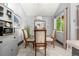 Cozy dining room featuring a modern chandelier, table and chairs by a window at 4070 S Atchison Way # 304, Aurora, CO 80014