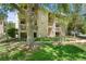 Attractive building exterior with lush lawn, mature trees, and charming balconies in a desirable community at 4070 S Atchison Way # 304, Aurora, CO 80014